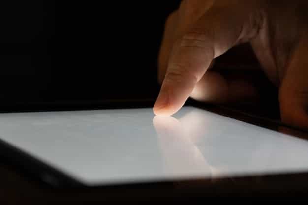A close-up on a hand pointing at fine print on a contract or streaming service agreement on a tablet screen, symbolizing the hidden fees and terms.