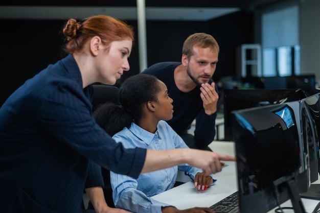 A group of employees participating in a cybersecurity training session. The instructor is showing a presentation about phishing scams.