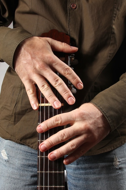 A close-up of a musician's fingers playing a complex chord on a guitar, representing the artistry and technical skill involved in music creation.