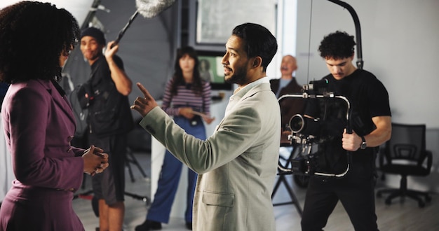A photograph of a diverse group of entertainment industry professionals (actors, directors, crew) participating in a workplace training session. The focus is on the presenter and engaged audience, set against a backdrop of a modern office space.